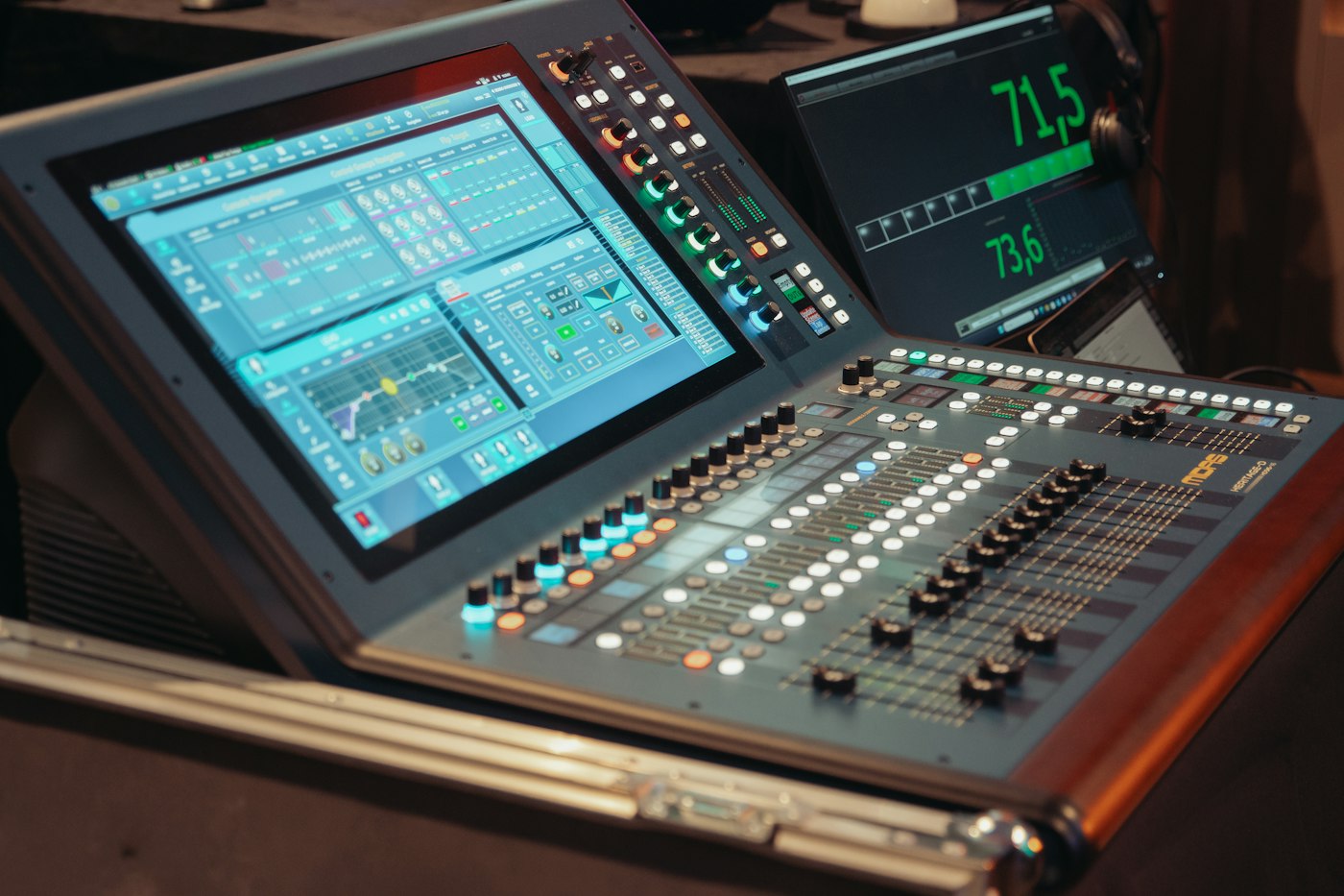 A professional audio mixing console with multiple faders.